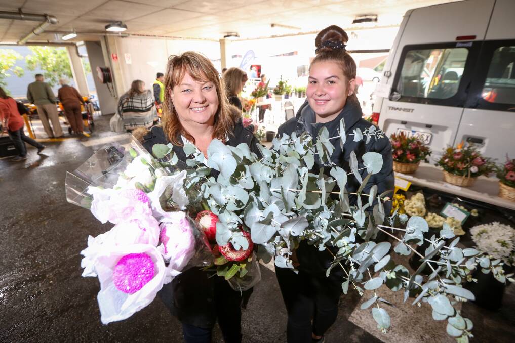 FLORAL FIND: Michelle and Amelia Bedggood, of Henty, buy flowers at Sunday's Kiewa Street Market in Albury. Picture: JAMES WILTSHIRE