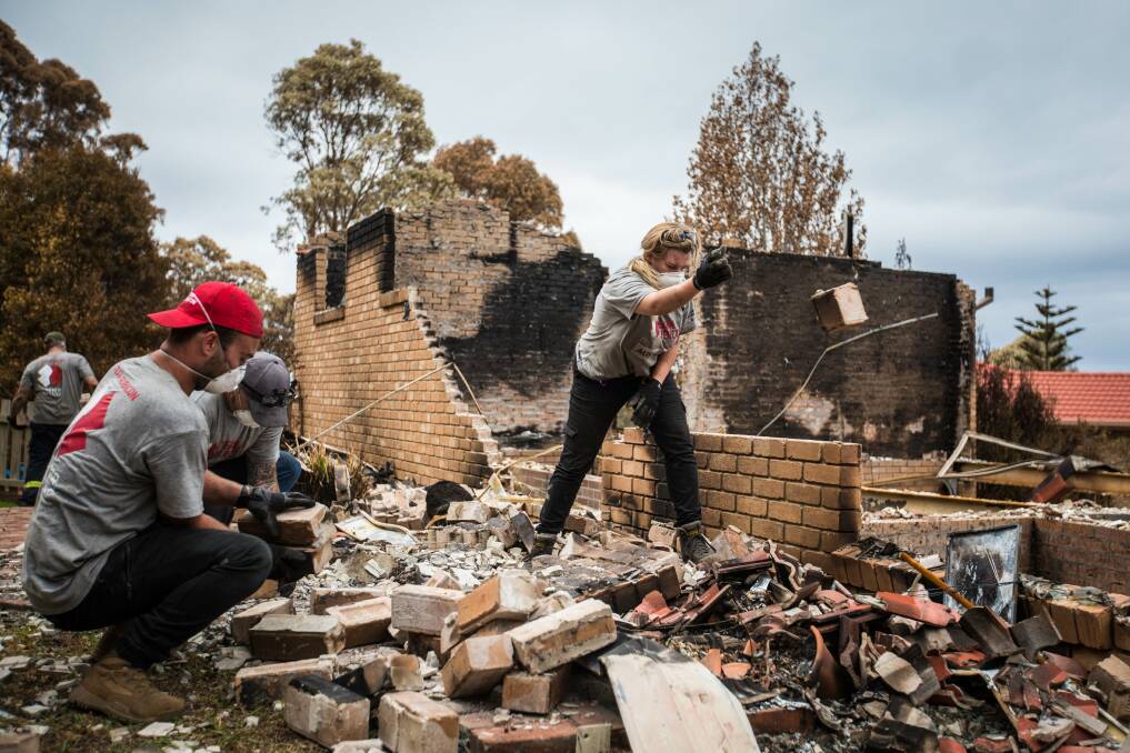 WILLING HANDS: Clearing up after a bushfire can seem an overwhelming task for a homeowner, but Team Rubicon Australia volunteers aim to lighten that load.
