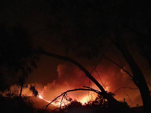 OUT OF CONTROL: Flames from the Walwa fire on Monday night. This photo was taken about 11.30pm from Burrowye. Picture: SUPPLIED