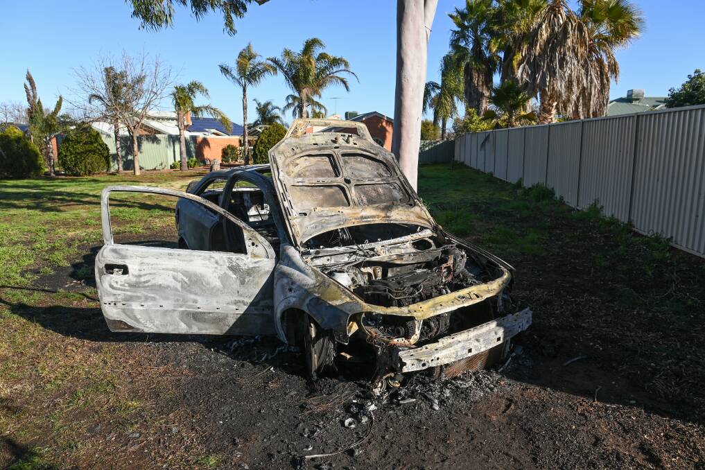 AFTERMATH: The burned-out car sits in the Corowa reserve where it had been abandoned earlier. Picture: MARK JESSER
