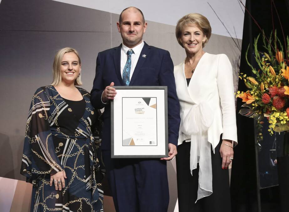 WELL DONE: Michael Edwards with last year’s winner Gemma Hartwig and Skills and Vocational Education Minister Michaelia Cash. Picture: TREVOR CONNELL
