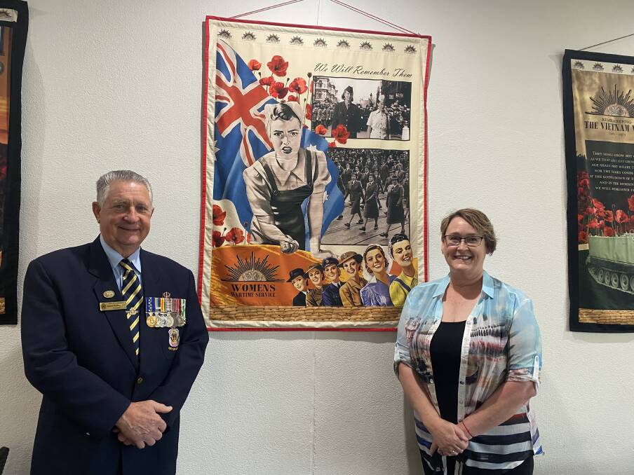 ON DISPLAY: Albury RSL sub branch president Graham Docksey with artist and ex-servicewoman Jan Townsend in front of the 'Women at War' wall hanging. Picture: SUPPLIED