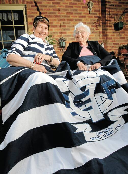 Joy Jeffery and Jean Keenan who turned 100 last week have made a banner to celebrate Yarrawonga making the grand final. Picture: DAVID THORPE