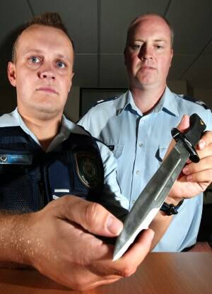 Albury Sen-Constable Matt Barnes and Wodonga Acting Sgt Mick Bourke with a 28-centimetre hunting knife that was seized on January 13. Picture: JOHN RUSSELL