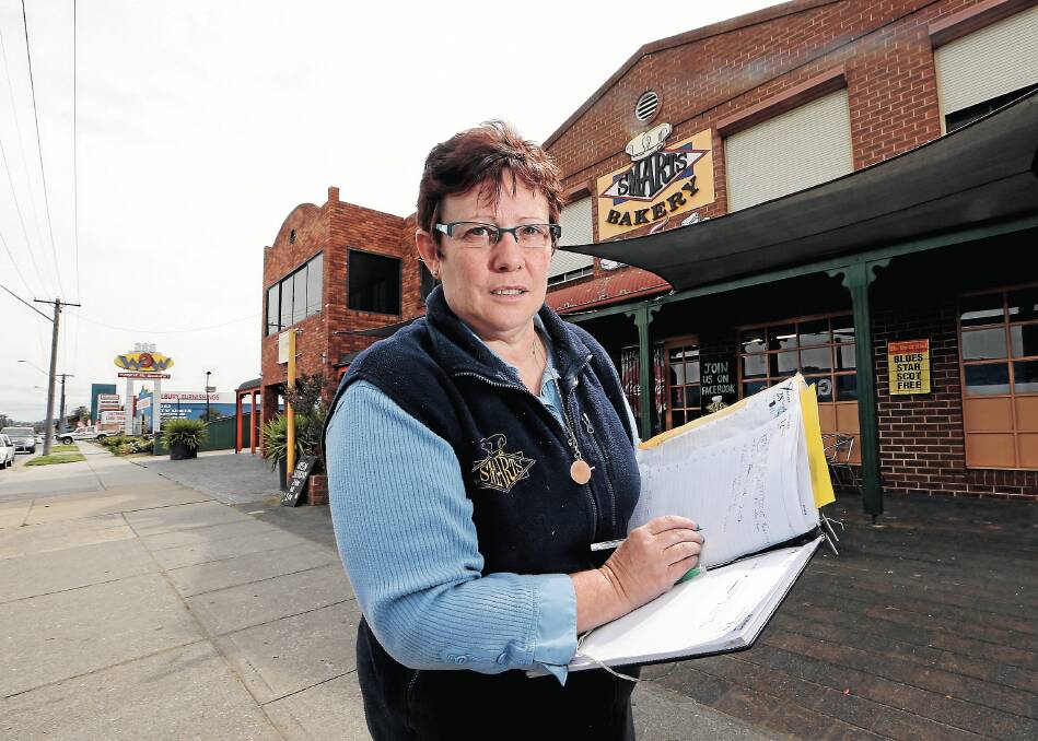 Joanne Duffy out the front of Smarts Bakery. Her business has been in steady decline since Grant’s Timber and Hardware closed in 2010. Picture: KYLIE ESLER