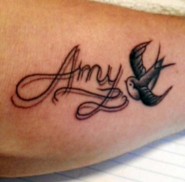ABOVE: A young Amy Dickinson (right) with sister Laura and parents Helen and Cam.
LEFT: Amy Dickinson who died at the age of 24.
BELOW: Cam Dickinson’s tattoo honouring Amy.