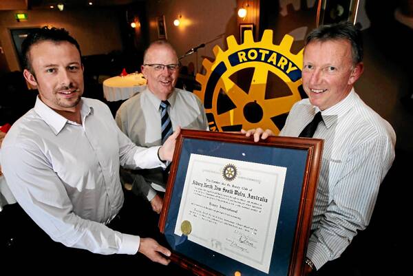 Sunrise president Conor Noonan, assistant District 9790 governor Terry Simmonds and Roger Schnelle with the new Rotary club’s charter. Picture: PETER MERKESTEYN