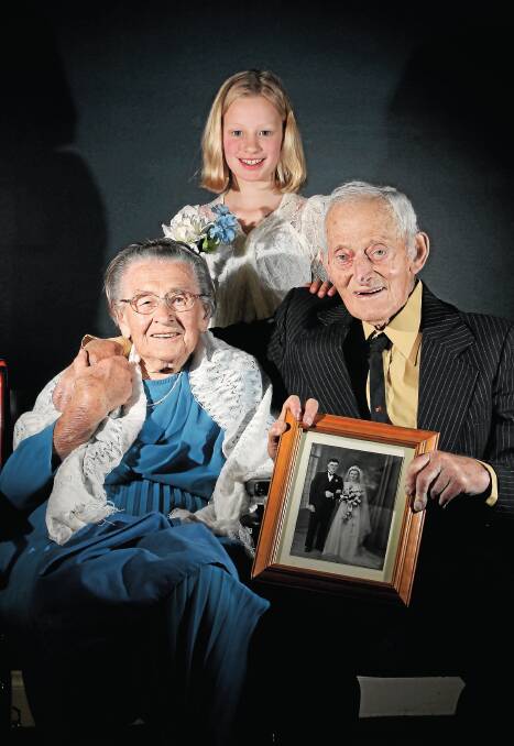 Linda and Norm Graetz with their great-grand-daughter, Mikhayla Pratt, 10, of Melbourne, wearing Linda’s wedding dress. Picture: MATTHEW SMITHWICK