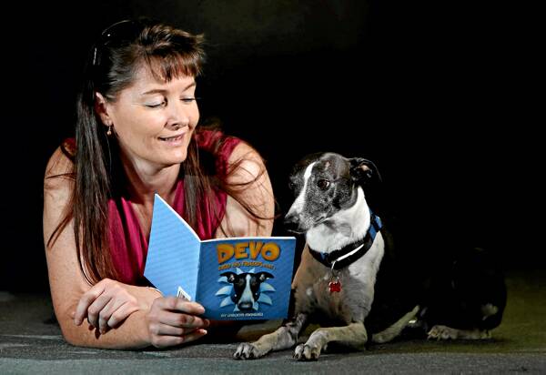 Carolyn Maxwell with the book she wrote about her diabetic alert dog Devo. Picture: KYLIE ESLER