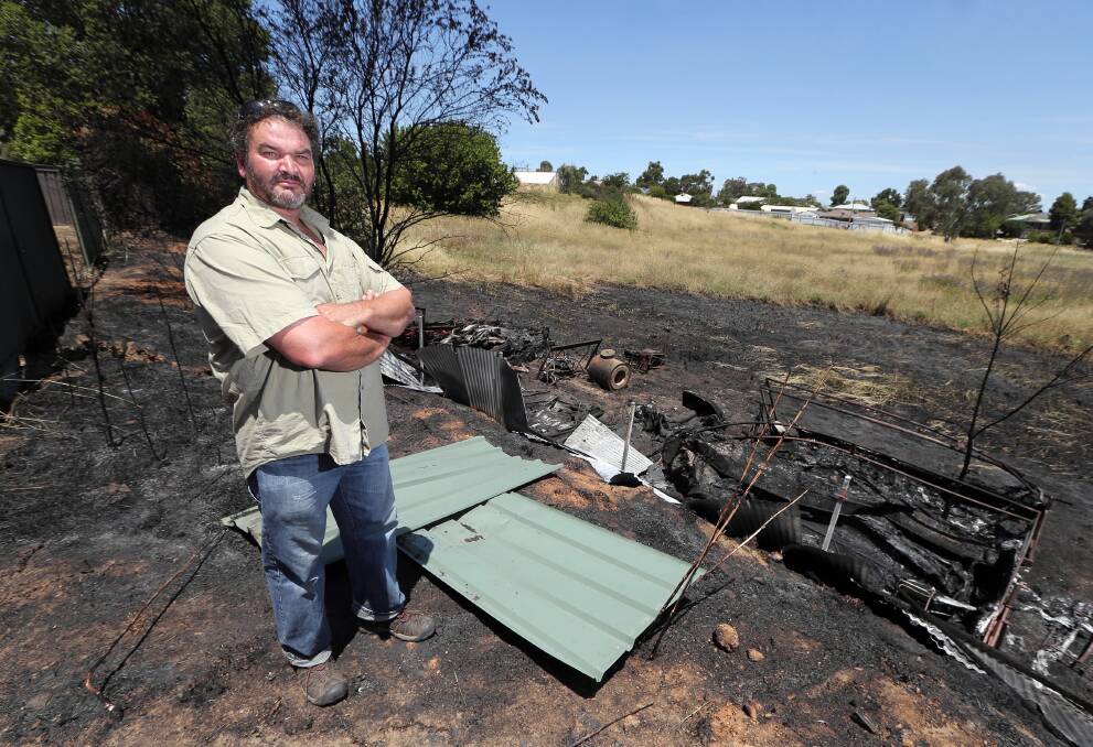 Steve Ford views his property that came close to being destroyed after an arson attack next door. Picture: JOHN RUSSELL