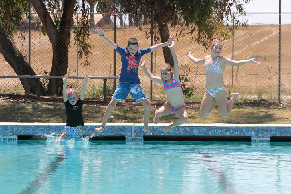 Jack Costigan, 7, Dylan Sidebottom, 11, Ella Costigan, 9, and Olivia Hayes, 12, all of Tungamah, cool off at the local pool while the temperature was hovering around 42.9 degrees. The pool only opened yesterday. Picture: TARA GOONAN