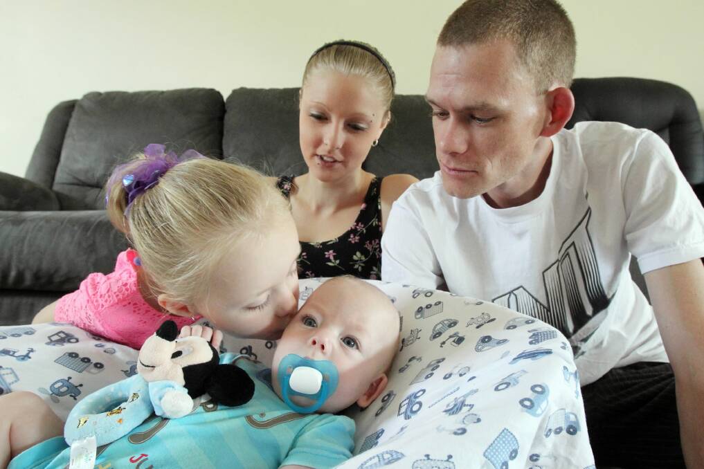 The day after Spencer Smith, six months, pictured with his sister, Bronwyn, and parents, Maddi Hawes and Aaron Smith, was photographed, he had surgery to control the condition hydrocephalus that he suffers. Picture: Mark Jesser