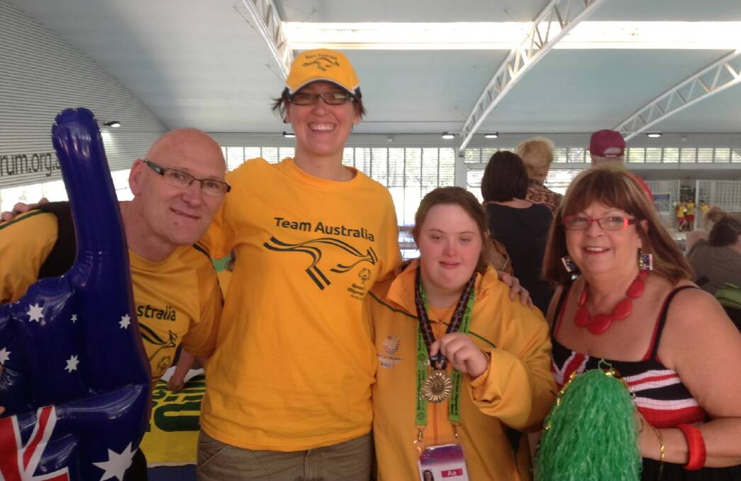 Gold medal winner Alannah McKeown is joined by her father Alan McKeown, sister Melanie McKeown and friend Lizzie Pogson after winning at the Special Olympics Asia Pacific Games in Newcastle.