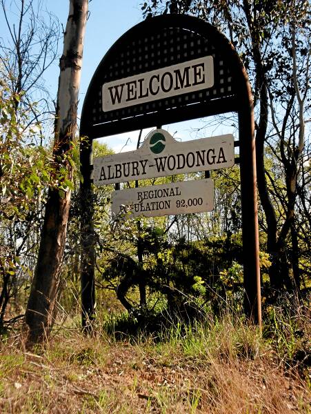 The last remaining “Welcome Albury-Wodonga” sign has become overgrown.