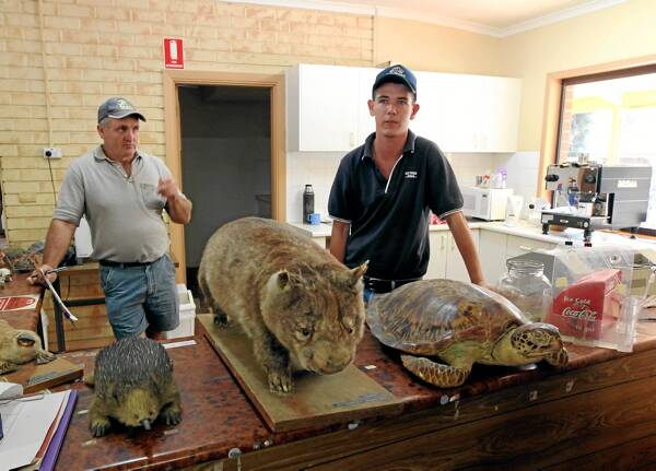 Darryl West and auctioneer Alex Smith put more of Oz-e-Wildlife’s mementoes under the hammer. Pictures: PETER MERKESTEYN