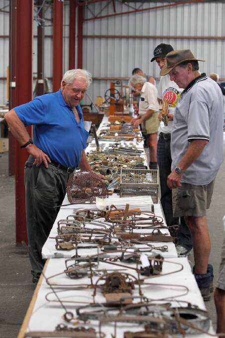Bargain-hunters look over the collection, which included a number of hand-crafted traps.