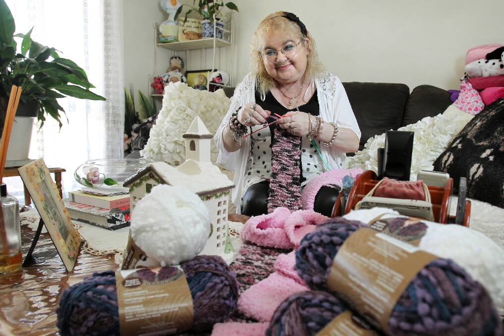 Kathy Barber doesn’t let serious illness get in the way of volunteering for Carevan with her daily knitting. Picture: MARK JESSER