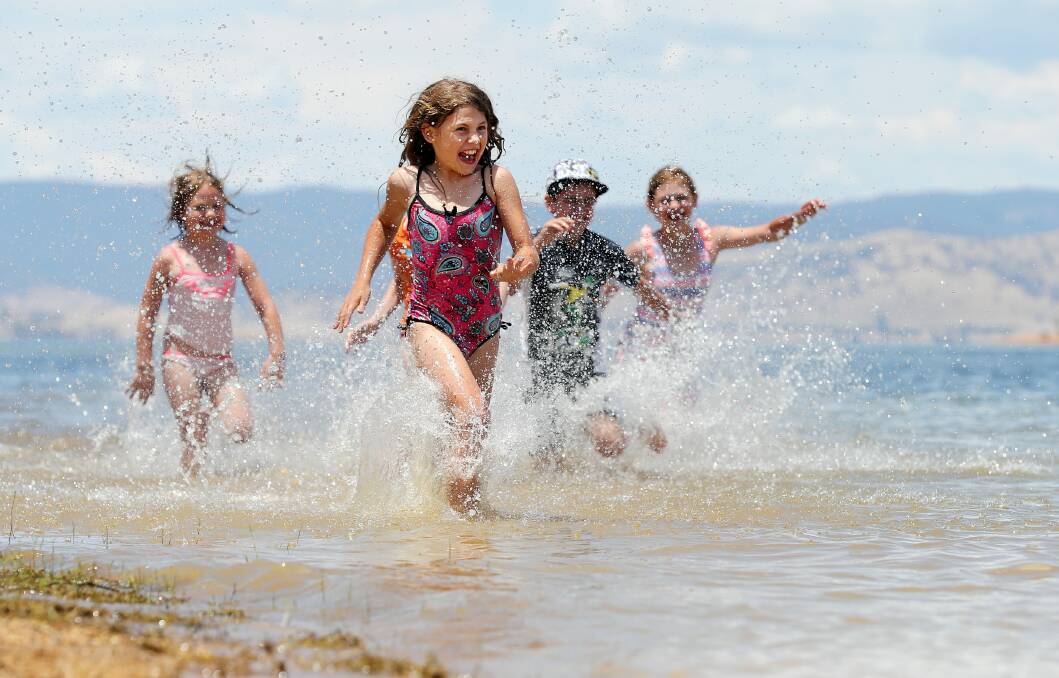 Megan Dickson, 9, splashes in the water at Kookaburra Point with her sisters Sarah, 6, and Caitlin, 11, with cousin Jasper Laughlin also in on the action.