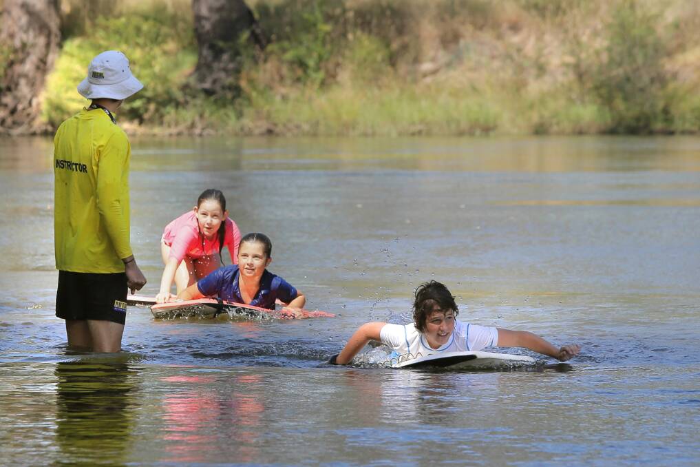 Life Saving Victoria instructor Conor Keely oversees Yackandandah students Siminee Vonthien, 11, Meg Pendergast, 10, and Ed Smith, 11, as they learn how to swim in, and respect, the Murray River in Albury. Picture: TARA GOONAN