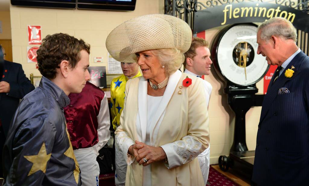 Camilla, the Duchess of Cornwall (C) speaks with British jockey Ryan Moore (L) and she and Prince Charles (R) meet the jockeys before the running of the Melbourne Cup horse race, in Melbourne.