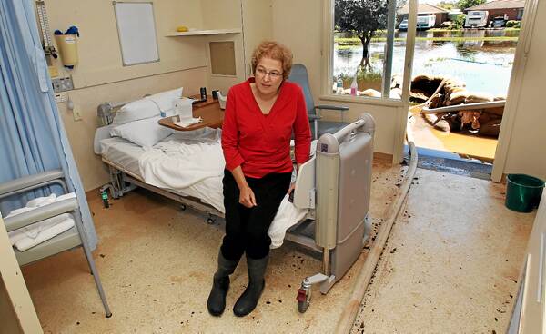 Numurkah District Health boss Jacqui Phillips in one of the hospital&rsquo;s flooded rooms. Pictures: FAIRFAX