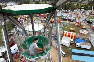 l Beau Williams, 18, from Wagga who operates the Giant Wheel takes in the views from the ride. Picture: KYLIE GOLDSMITH