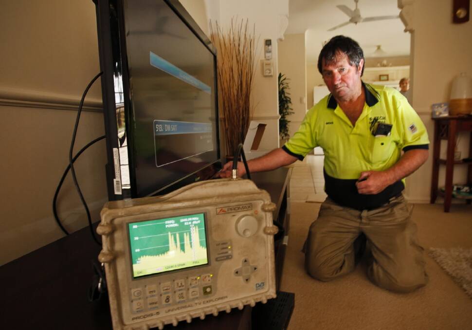 Hi-Tech Antennas owner Brian Crichton measures signal strength as people cannot access some channels because of a Foxtel fault. Picture: BEN EYLES