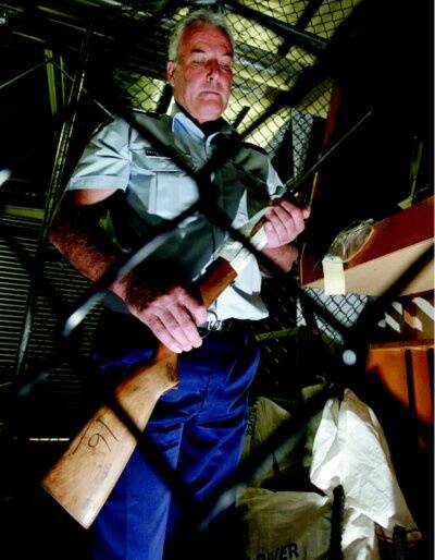 Sgt Garry Corcoran examines one of the weapons surrendered to Wodonga police during the month-long amnesty. Picture: KYLIE GOLDSMITH
