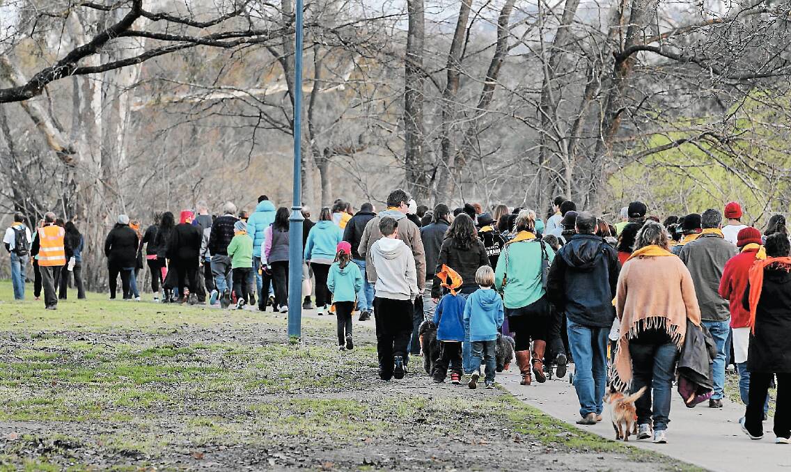 Participants walk towards Gateway Island during Lifeline’s Out of the Shadows Walk. Picture: DAVID THORPE