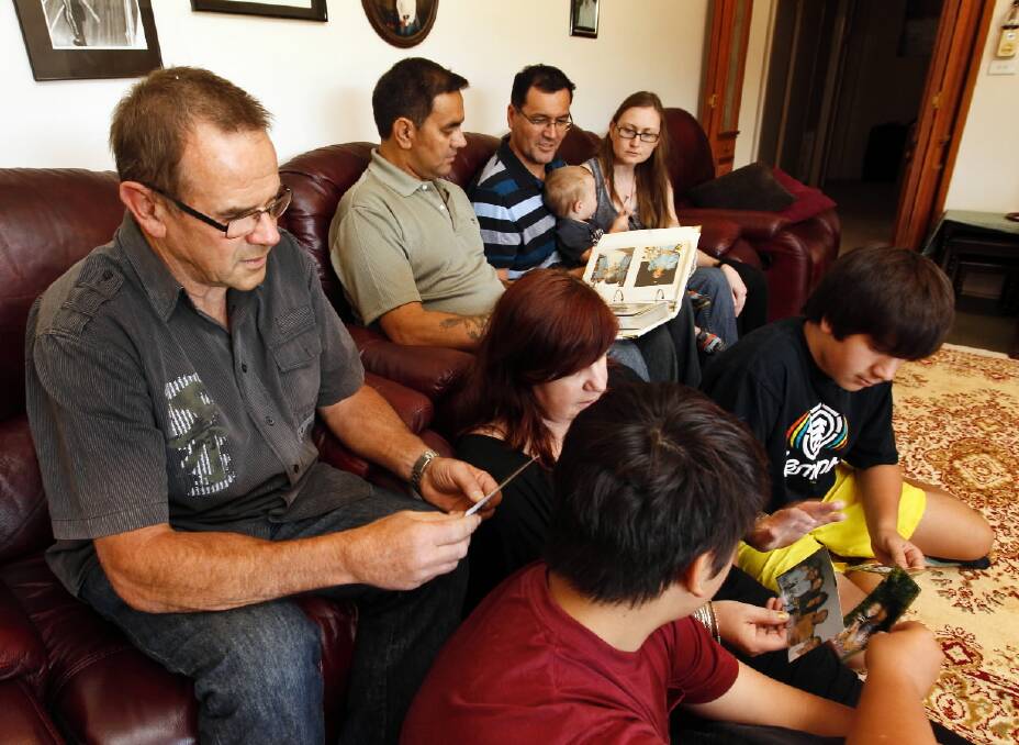 Wilma Caldwell’s family Werner Osewald and Gary, Jay, Caine, Claire, Sharon, Bryse, 13, and Rheman, 16, Caldwell look through photos. Picture: BEN EYLES
