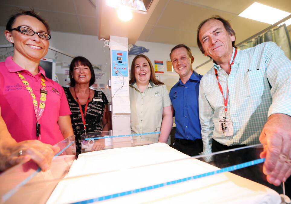 Paediatric nurse Joanna Owen, nurse director Zane Healy, Woolworths’ Liza Hill, unit manager Mick Enright and Dr Mike Taylor were delighted the resuscitaire is about to be replaced. Picture: JOHN RUSSELL