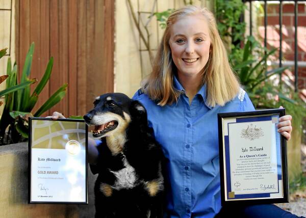 Kate Millward, 18, and her dog, Fly, with her Queen’s Guide and Duke of Edinburgh awards. Picture: PETER MERKESTEYN