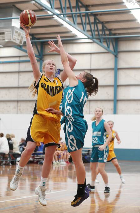 Goldminers player Ella Hellessey powers over Rose Davison of NZ Koru. Pictures: JOHN RUSSELL