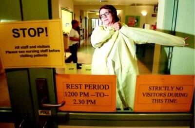 Wodonga hospital infection control co-ordinator Sue Nelson prepares to enter an isolation ward. Picture: KYLIE GOLDSMITH