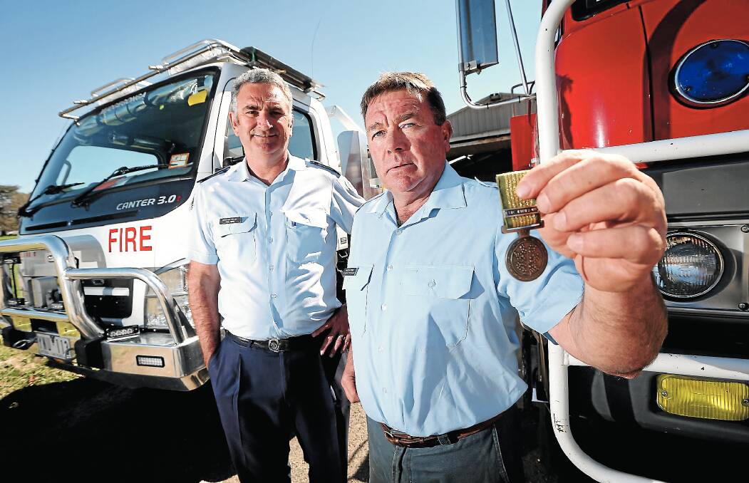 National Emergency Medal winners Paul King and Andrew Cross outside the Mudgegonga CFA shed. Picture: JOHN RUSSELL