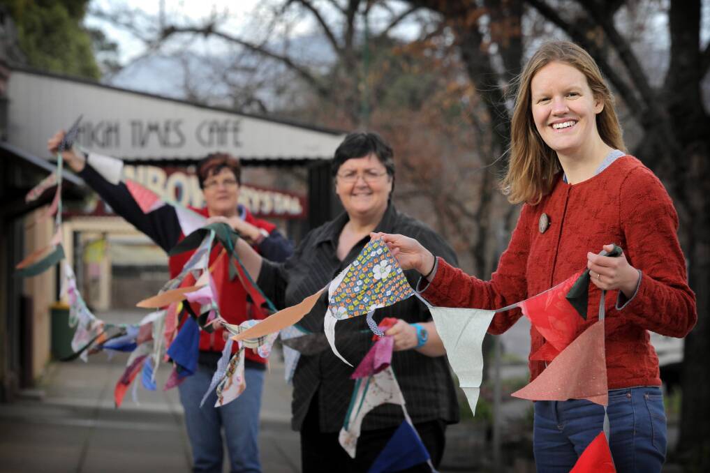 Denise Maybury, Judy Davis and Lauren Salathiel show off their bunting efforts so far in the project linked to the Yackandandah Community Education Network. They are hoping to set a Guinness World Record. Picture: TARA GOONAN