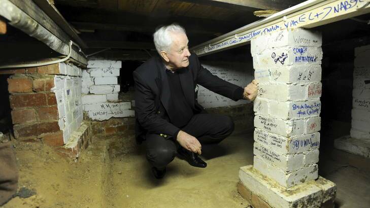 73-year-old Ross Thomas of Chapman, inspects markings on the wall.