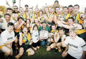 Moyhu players and coach Gil Ould celebrate their grand final success in the Ovens and King league. Pictures: SIMON GROVES