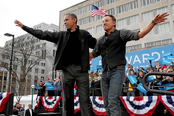 Barack Obama and rocker Bruce Springsteen wave to the crowd during a rally on the last day of campaigning. Picture: GETTY IMAGES