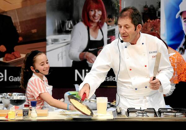 Lucy Bonanno and celebrity chef Gabriel Gate cook at the Albury HomeXpo on Saturday. Picture: JOHN RUSSELL