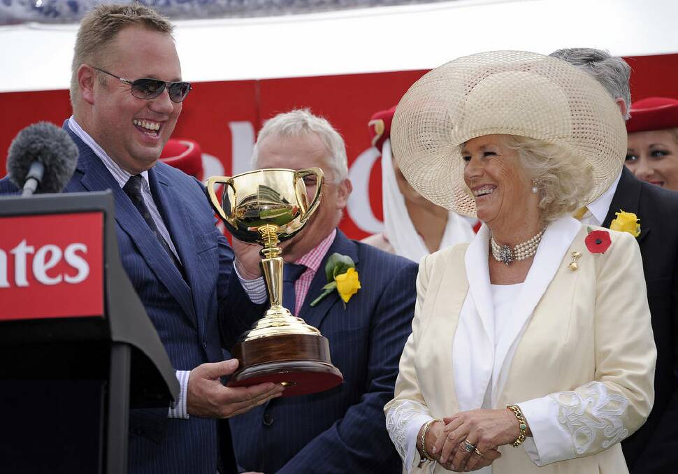 Owner of Green Moon Nick Williams, left, smiles after receiving the winners trophy from Camilla, the Duchess of Cornwall, at the Melbourne Cup at Flemington Race Course in Melbourne, Australia.