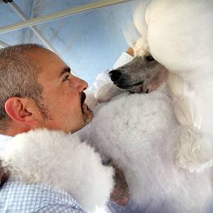  Michael Sarroff, of Albury, gets a hug from Giselle, his standard poodle.