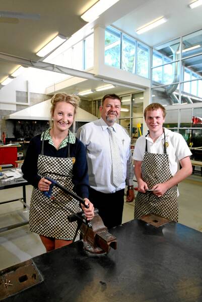 Students Chloe Jones and Kieran Robinson looked over the new metalwork area with principal Phil Rogers yesterday. Picture: MATTHEW SMITHWICK