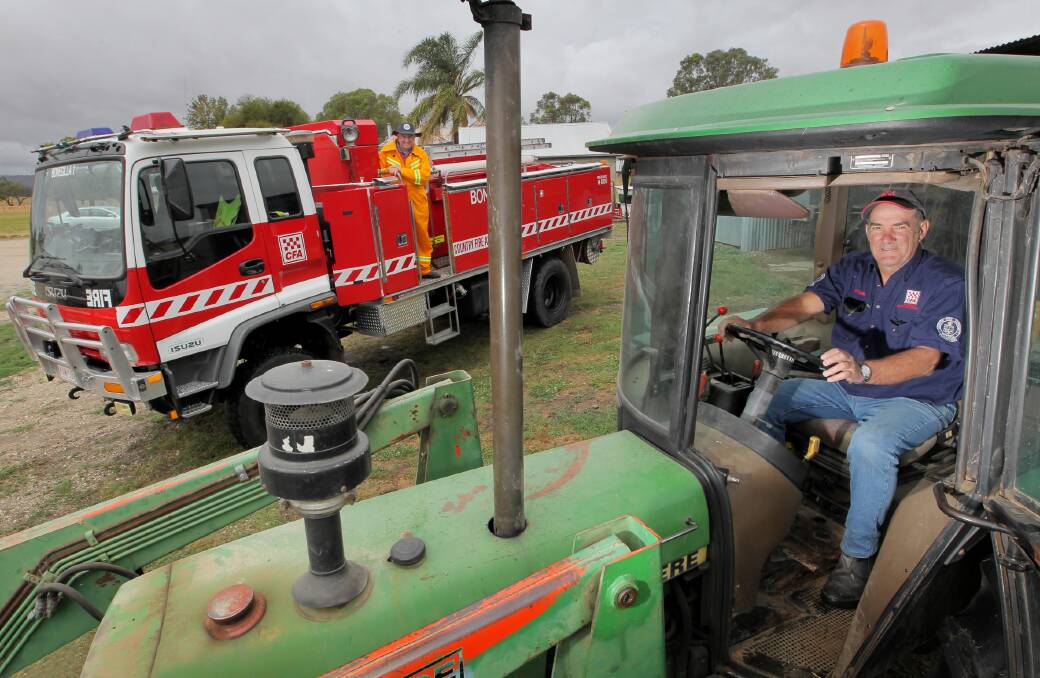 Bonegilla fire brigade member Kevin Peard and captain Brian Church gear up for Sunday’s auction in Mahers Road aimed at raising money for a new fire tanker. Picture: DAVID THORPE