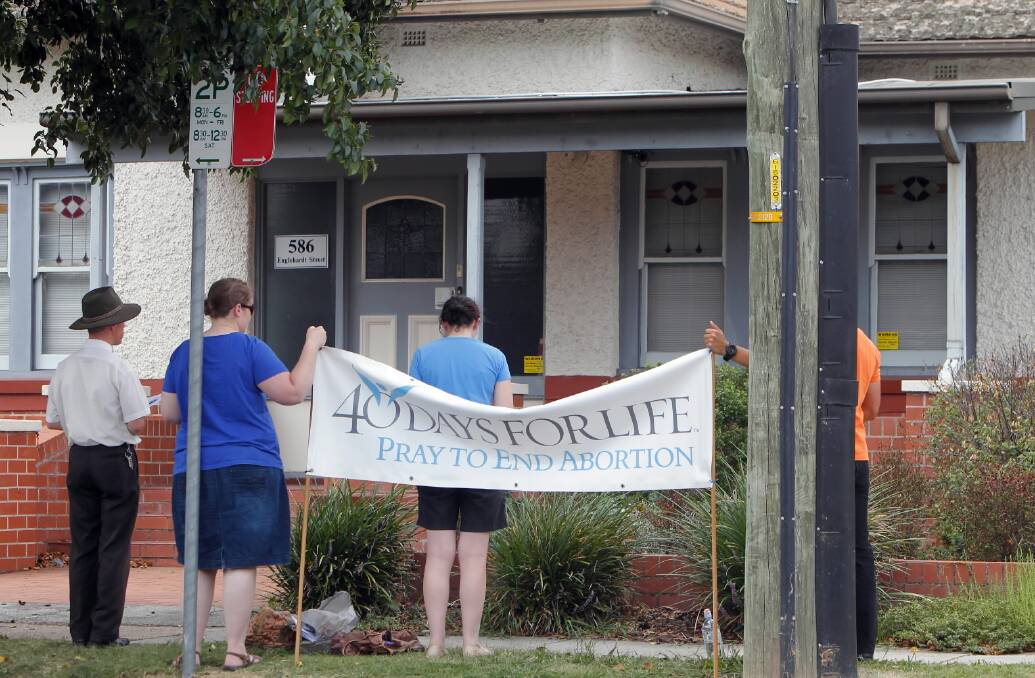 Volunteers from the 40 Days for Life group pray outside the abortion clinic. Picture: KYLIE ESLER