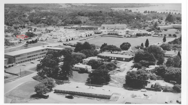 An aerial taken in 1961 of Duntroon. The red arrow points to the large gum tree behind the Cork Block where dirt from the 'hole' was initially dumped by cadets