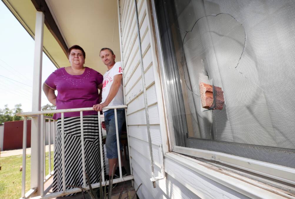 Natalie Ricci and Neil Rousu survey the damage to their Wodonga home after a car slammed through its front fence. Pictures: JOHN RUSSELL, STEVE SMITH