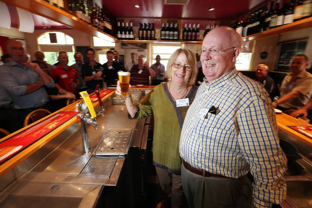 Christine Hanley from the McEvoy Tavern in Eldorado shows Australian Hotels Association executive officer Bill Bell the skills that won her the “best beer pour” competition yesterday. Picture: JOHN RUSSELL