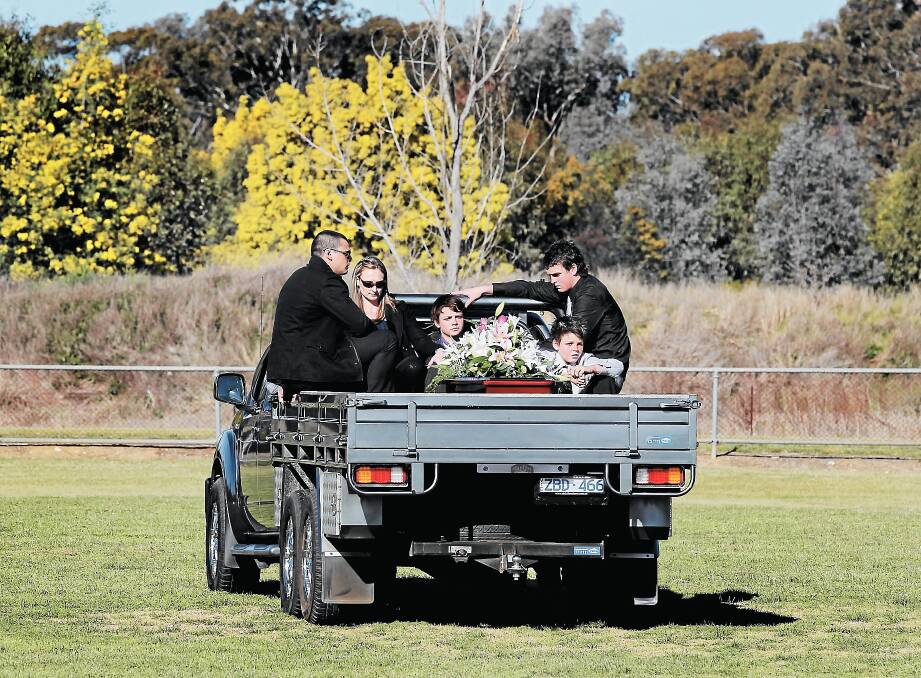 Merv Neagle’s family did a lap of honour on the back of former Essendon teammate Paul van der Haar’s ute at the Walla Sportsground. INSET: Neagle’s niece Jessica sings at the funeral. Pictures: DAVID THORPE