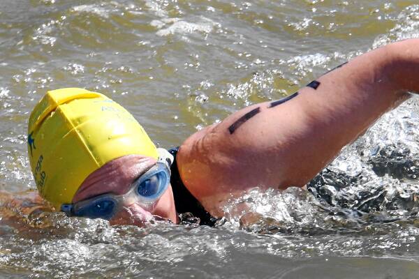 Tricia Bowman swims across the dredge hole at Allans Flat on her way to the next leg. Pictures: PETER MERKESTYN